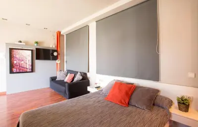 a bedroom with a large screen above a bed at Sky Touristic Attic in Valencia