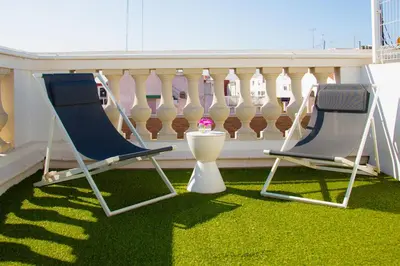 two chairs and a table on a balcony at Sky Touristic Attic in Valencia