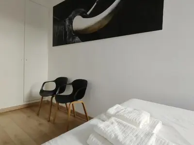 a bedroom with two chairs and a picture on the wall at Hola Valencia - Holiday Apartments in Valencia