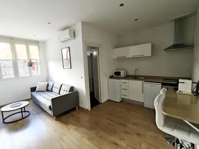 a living room with a couch and a kitchen at Hola Valencia - Holiday Apartments in Valencia