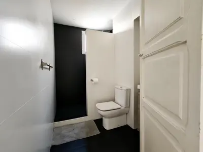 a bathroom with a white toilet and a door at Hola Valencia - Holiday Apartments in Valencia