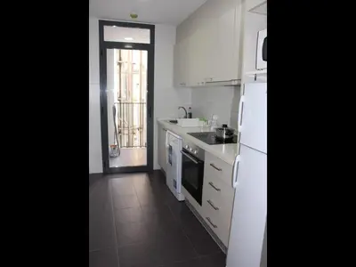 a white kitchen with a sink and a refrigerator at Apartment Sofi in Valencia