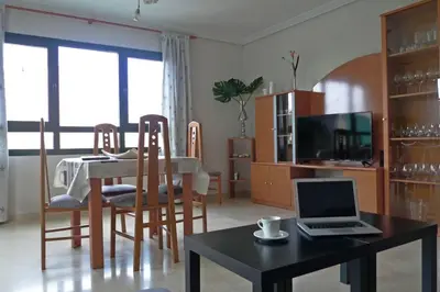 a living room with a table with a laptop on it at Apartamento en la Ciudad de las ciencias in Valencia