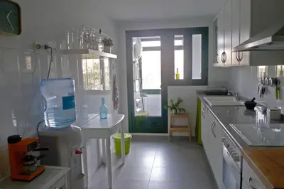 a kitchen with white cabinets and a large window at Apartamento en la Ciudad de las ciencias in Valencia
