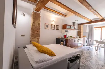 a bedroom with a bed with yellow pillows on it at FLORIT FLATS - Charming Ruzafa Apartment & Terrace in Valencia
