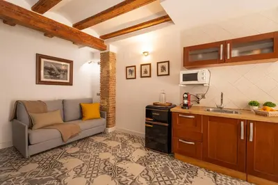 a living room with a couch and a kitchen at FLORIT FLATS - Charming Ruzafa Apartment & Terrace in Valencia