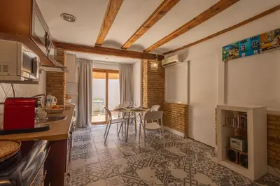a kitchen with a table and a dining room at FLORIT FLATS - Charming Ruzafa Apartment & Terrace in Valencia