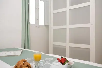 a table with a plate of food and fruit on it at Antiguo Reino Apartment in Valencia