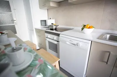 a kitchen with a sink and a counter with oranges on it at Antiguo Reino Apartment in Valencia