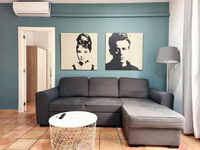a living room with a couch and posters of men at Flats Friends Nave in Valencia