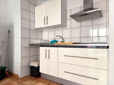 a kitchen with white cabinets and a sink at Flats Friends Nave in Valencia