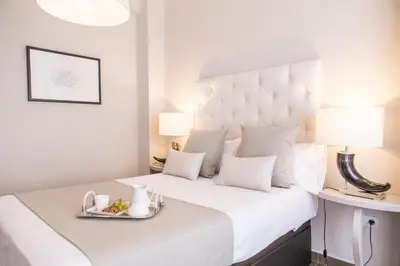 a hotel room with a bed with a tray of food on it at MD Oliag in Valencia