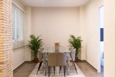 a dining room with a table and chairs and plants at MD Oliag in Valencia