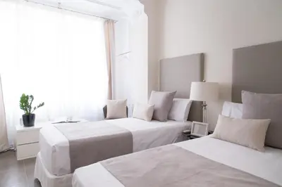 a hotel room with two beds and a window at MD Oliag in Valencia