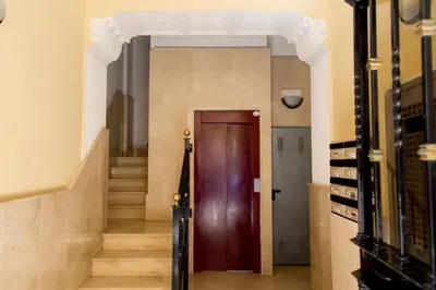 a hallway with a wooden door and stairs at MD Oliag in Valencia