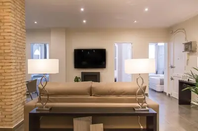 a living room with a couch and two lamps at MD Oliag in Valencia