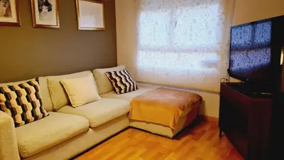 a living room with a couch and a television at Santos Studio 2 in Valencia