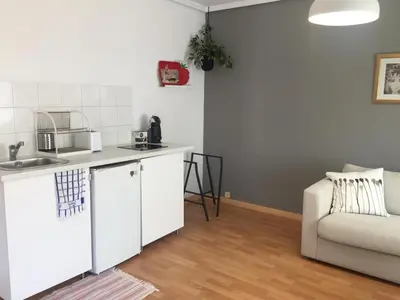 a kitchen with a sink and a couch in a room at Santos Studio 2 in Valencia