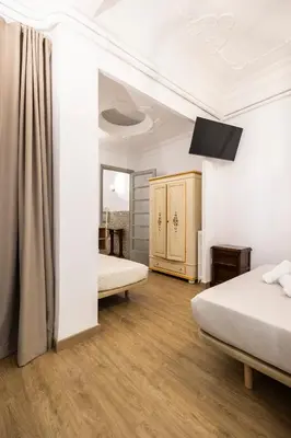 a bedroom with two beds and a mirror at Live in Chianti Apartaments by Concept Flats in Valencia