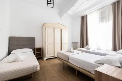 a bedroom with two beds and a window at Live in Chianti Apartaments by Concept Flats in Valencia