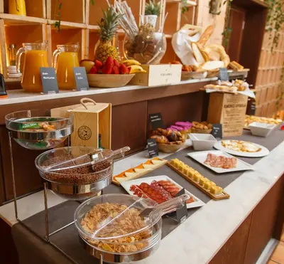 a buffet with different types of food on a counter at La Orza de Angel in Chiva