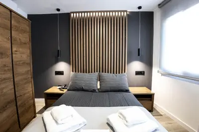 a bedroom with a bed with a wooden headboard at La Orza de Angel in Chiva