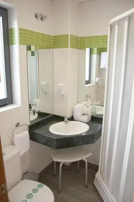a bathroom with a sink and a toilet and a mirror at Hotel Vista al Sol in Paterna