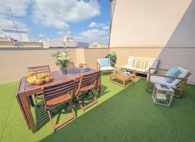 a patio with a table and chairs on a balcony at HQ Rooms Apartments San Vicente in Valencia
