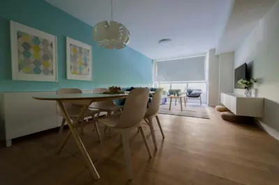 a dining room with a table and chairs at HQ Rooms Apartments San Vicente in Valencia