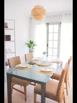 a dining room with a blue table and chairs at Cozy apartment on the sea in Port Saplaya