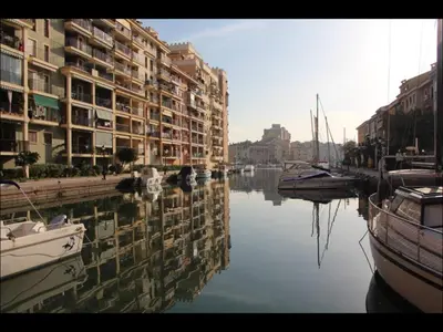 a body of water with buildings and boats in it at Cozy apartment on the sea in Port Saplaya