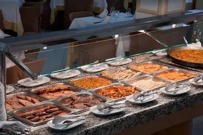 a buffet line with many different types of food at Olympia Ronda Hostel in El Puig