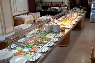 a buffet line with many different types of food at Olympia Ronda Hostel in El Puig