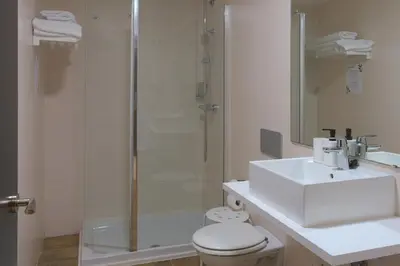 a bathroom with a shower and a toilet and a sink at Dormavalencia Hostel Regne in Valencia