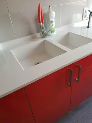a kitchen with a sink and red cabinets at Avenue Rooms in Valencia