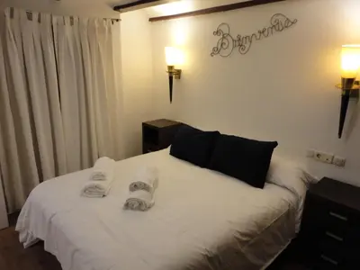 a bedroom with a white bed with towels on it at Center Valencia in Valencia