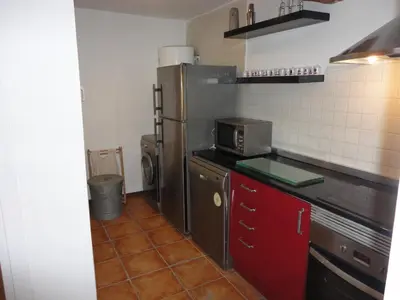 a kitchen with a refrigerator and a red cabinet at Center Valencia in Valencia