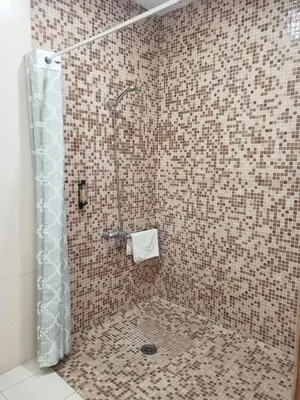 a shower with a glass door in a bathroom at Balcón Al Mar in Valencia