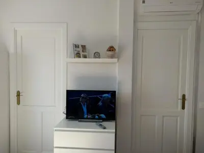 a room with two white doors and a tv on a shelf at Piso céntrico Plaza Toros in Valencia