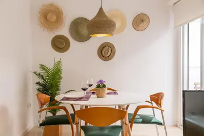 a dining room with a white table and chairs at Valencia Just in the Middle in Valencia