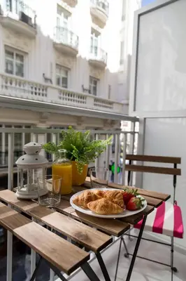 a table with a plate of bread and fruit on it at Valencia Just in the Middle in Valencia