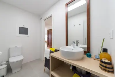 a bathroom with a sink and a toilet and a mirror at Valencia Just in the Middle in Valencia