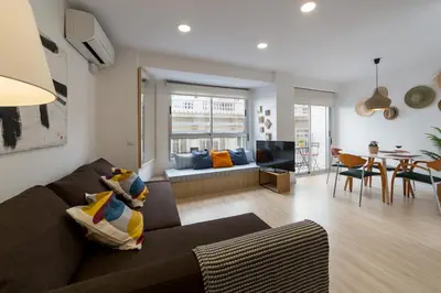 a living room with a couch and a dining room at Valencia Just in the Middle in Valencia