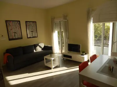 a living room with a couch and a tv at El Católico 56 in Valencia