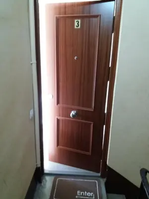 a wooden door in a hallway with the number b on it at El Católico 56 in Valencia