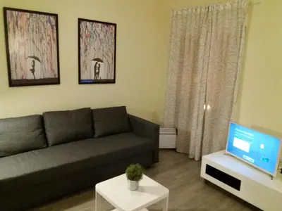 a living room with a couch and a tv at El Católico 56 in Valencia