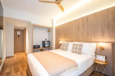 a bedroom with a large bed and a wooden wall at Nommadas Jero - Only Adults in Valencia