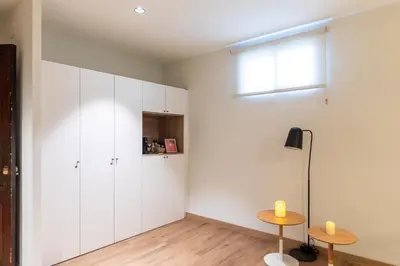 a room with white cabinets and a table and a window at Nommadas Jero - Only Adults in Valencia