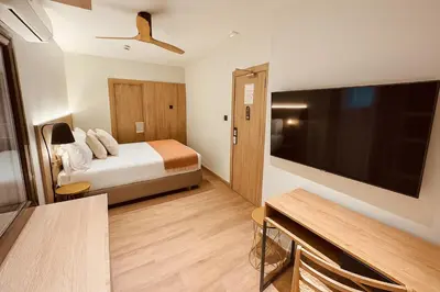 a hotel room with a bed and a flat screen tv at Nommadas Jero - Only Adults in Valencia