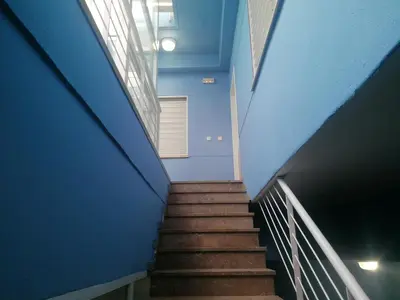 a stairway in a building with blue walls and stairs at Apartamento playa Las Arenas in Valencia